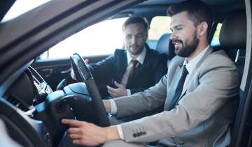 Salesperson demonstrating car to customer