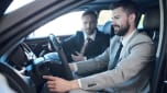 Salesperson demonstrating car to customer