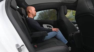 New Mercedes CLA being tested in the UK - rear interior, seat being sat in by Auto Express ex-chief reviewer Alex Ingram 