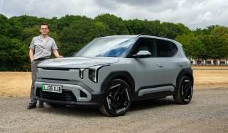 Kia EV2 Long Range - front static with Auto Express consumer reporter Tom Jervis stood next to the car
