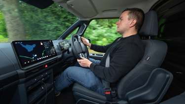 Auto Express senior content editor Shane Wilkinson driving the Kia PV5 Cargo