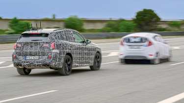 BMW X3 prototype (camouflaged) and dummy test car - front