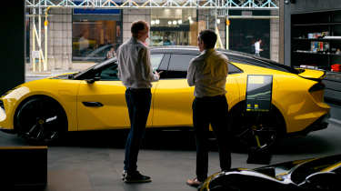 Auto Express editor-at-large Phil McNamara standing next in front of a Lotus Emeyal