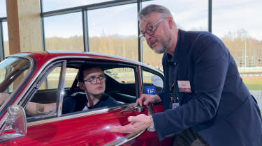 Auto Express consumer reporter Tom Jervis sitting in a Volvo P1800