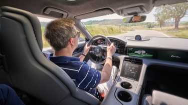 Auto Express contributor Antony Ingram driving the Porsche Taycan Turbo S Sport Turismo with E-Shift