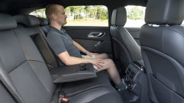Auto Express chief reviewer Alex Ingram sitting in back seat of the facelifted Range Rover Velar