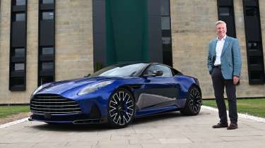 Aston Martin CEO Adrian Hallmark next to a Vanquish
