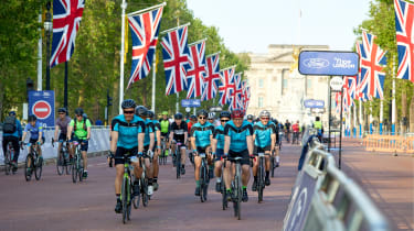 Driving Electric &amp; Carbuyer editor Richard Ingram cycling down Pall Mall as part of racing event