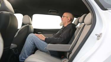 New BYD Seal 6 DM-i Touring - rear seats being sat in by Auto Express senior test editor Dean Gibson 