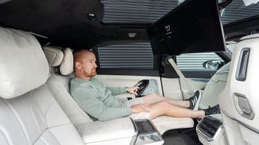 BMW 7 Series Chief Reviewer Alex Ingram reclining in rear seats