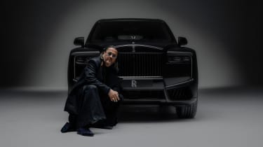 Cyril Kongo crouching in front of the Rolls-Royce Black Badge Cullinan by Cyril Kongo