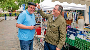 Dacia CEO Denis Le Vot fitting a hat on John McIlroy&#039;s head