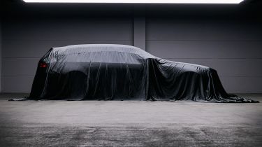 BMW M5 Touring teased - side profile under a sheet