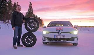 John Barker standing next to two wheels and a VW Golf