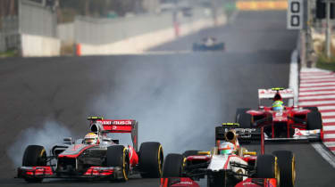Narain Karthikeyan gets outbraked by Lewis Hamilton in the Korean Grand Prix
