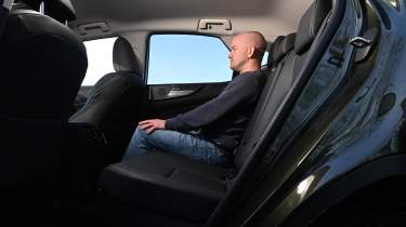 Lexus NX - rear seats being sat in by Auto Express chief reviewer Alex Ingram 