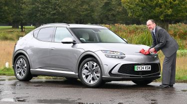 Auto Express chief sub-editor Andy Pringle washing the Genesis GV60