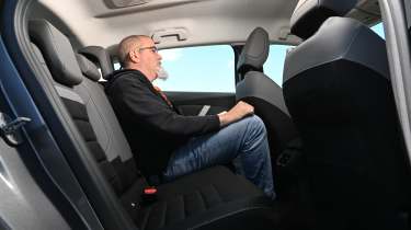 Citroen e-C4 - rear seats being sat in by Auto Express senior test editor, Dean Gibson