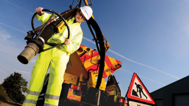 Chris Ebbs repairs a big ol' pothole