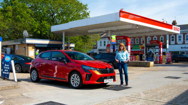 Auto Express pictures editor Dawn Grant standing next to the Renault Clio at an Esso forecourt