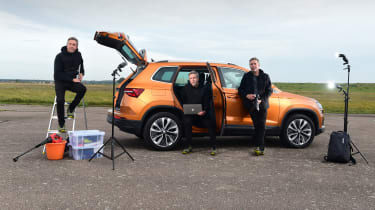 Auto Express staff photographer Pete Gibson standing in various poses next to the Skoda Karoq