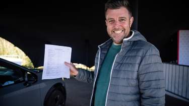 Auto Express head of digital content Steve Walker holding the Nissan Ariya&#039;s condition report
