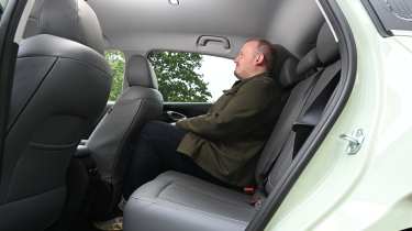 New Geely EX2 - rear seats being sat in by Auto Express news reporter Ellis Hyde