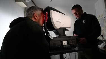 Auto Express consumer editor Chris Rosamond looking into an eye-testing machine