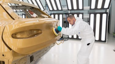 Bentley technician polishing a freshly-painted Bentley Bentayga