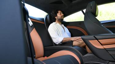 Auto Express news editor Jordan Katsianis sitting in the Bentley Continental GT's rear seat