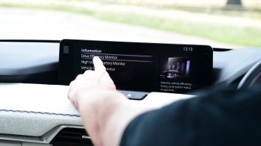 Auto Express chief sub-editor Andy Pringle operating the Mazda CX-60&#039;s infotainment system