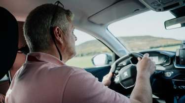 Auto Express consumer editor Chris Rosamond driving a Peugeot 208