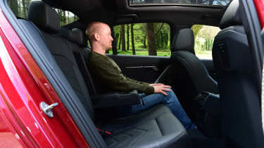 Auto Express chief reviewer Alex Ingram sitting in the BMW 530e's back seat