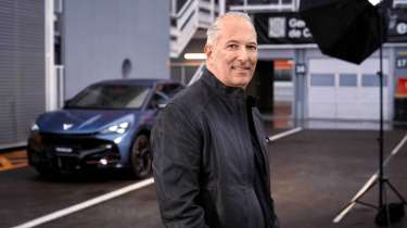 Cupra CEO Markus Haupt standing next to a car