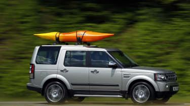 Land Rover Discovery with a boat on the roof