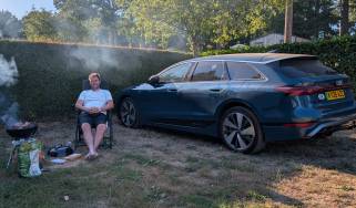 Auto Express head of digital content Steve Walker sitting between the Audi A6 Avant e-tron and a barbecue