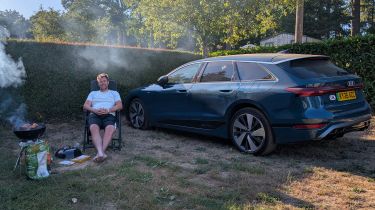 Auto Express head of digital content Steve Walker sitting between the Audi A6 Avant e-tron and a barbecue