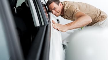 man stroking car
