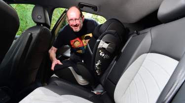 Auto Express chief sub-editor Andy Pringle fitting a child seat into the Volkswagen ID.3
