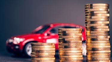 Pile of coins in front of a toy car