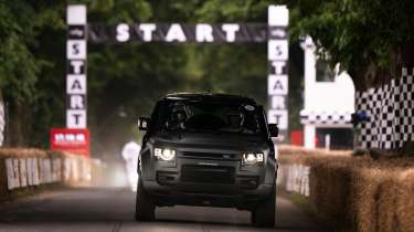 Land Rover Defender OCTA driving up the Goodwood hill climb