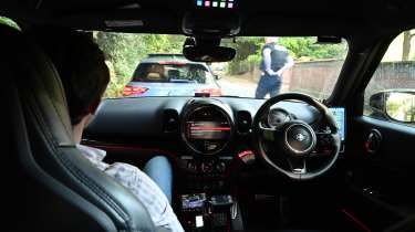 Auto Express consumer reporter Tom Jervis sitting in a police car