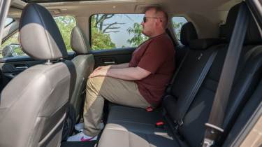 Auto Express news reporter Ellis Hyde sitting in the Nissan X-Trail's mid-row seat
