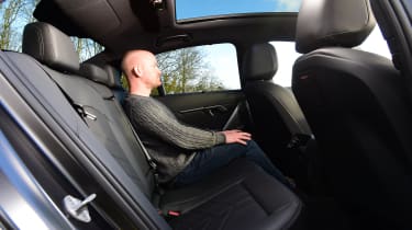 Auto Express chief reviewer Alex Ingram sitting in the back seat of the BMW i5