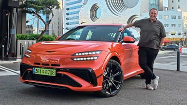 Thomas Geiger standing next to the Genesis GV60 Magma