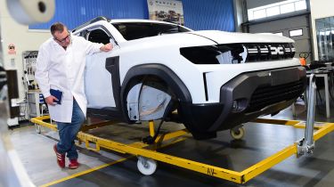 John McIlroy inspecting a Dacia Duster bodyshell