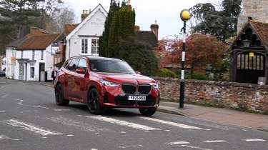 BMW X3 30e xDrive M Sport driving towards a Zebra crossing