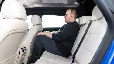 Auto Express news reporter Ellis Hyde sitting in the Mercedes CLA Shooting Brake's rear seat