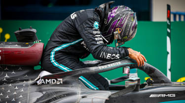 Lewis Hamilton climbing into F1 car
