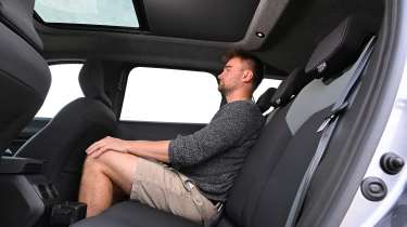 New Dacia Bigster 4x4 - rear interior, seats being sat in by Auto Express senior news reporter Alastair Crooks 